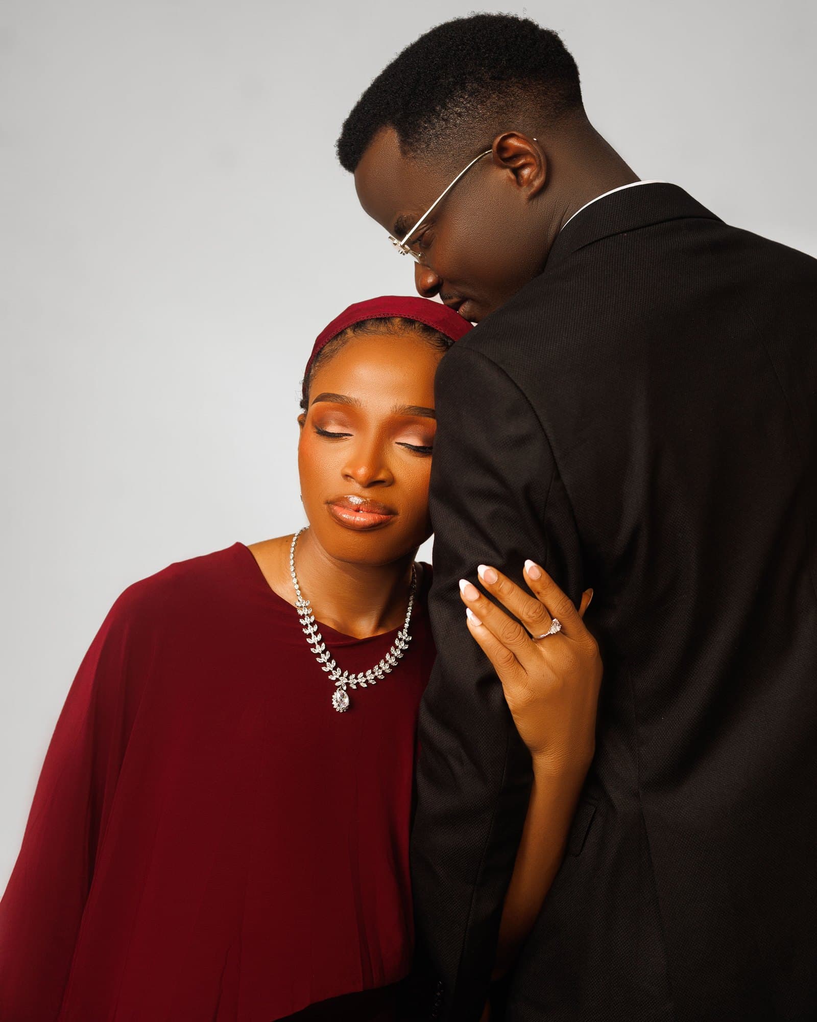 Scholarstica and Joseph in an intimate black and white portrait with her engagement ring